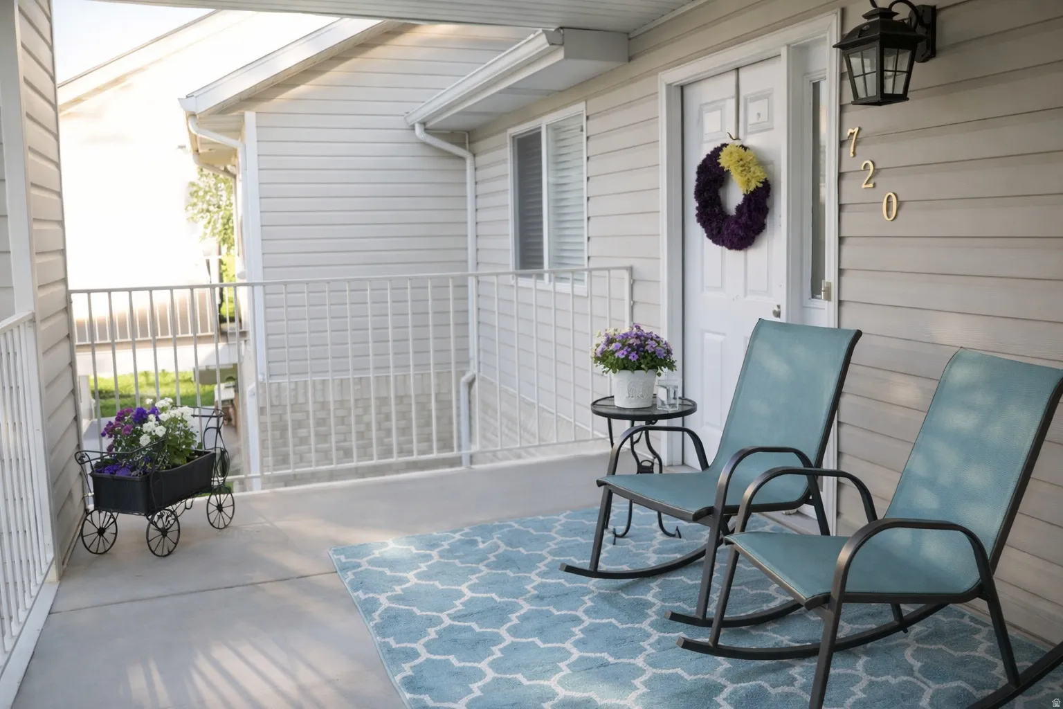 Covered front porch with white vinyl siding