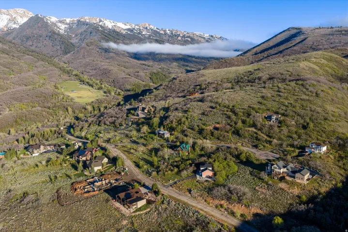 Aerial mountain community showcasing multiple residential structures and winding roads