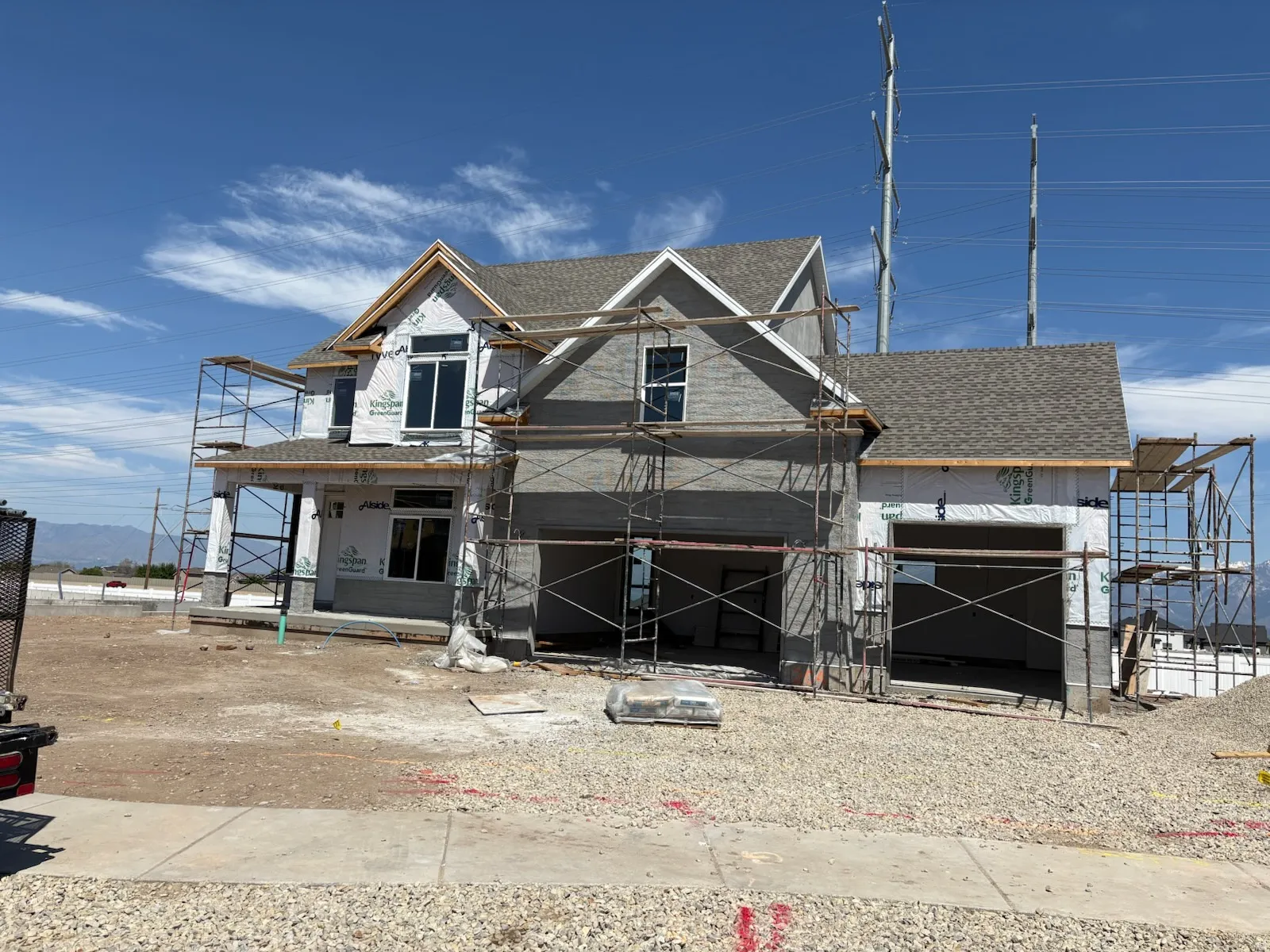 New construction residence featuring a two-story design with a prominent front entrance, 3 car garage , and a shingled roof