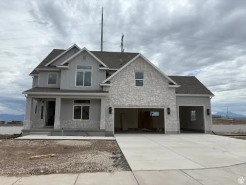 Modern two-story residence featuring light gray siding and stone accents