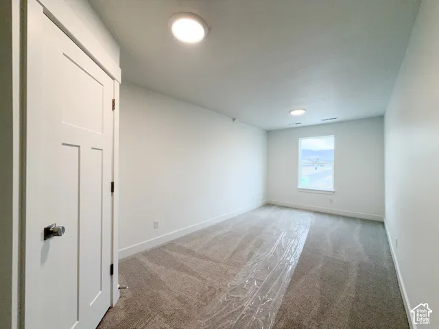 Recessed lighting, window, white walls, and carpeted flooring