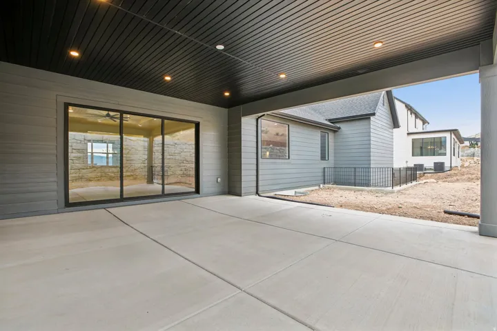 Covered patio with recessed lighting, concrete flooring, and sliding glass doors