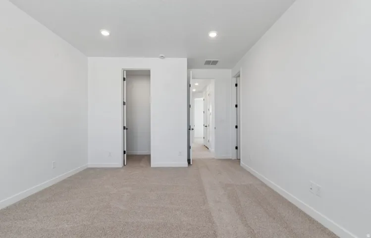 Neutral-toned carpet flooring complementing white walls and trim