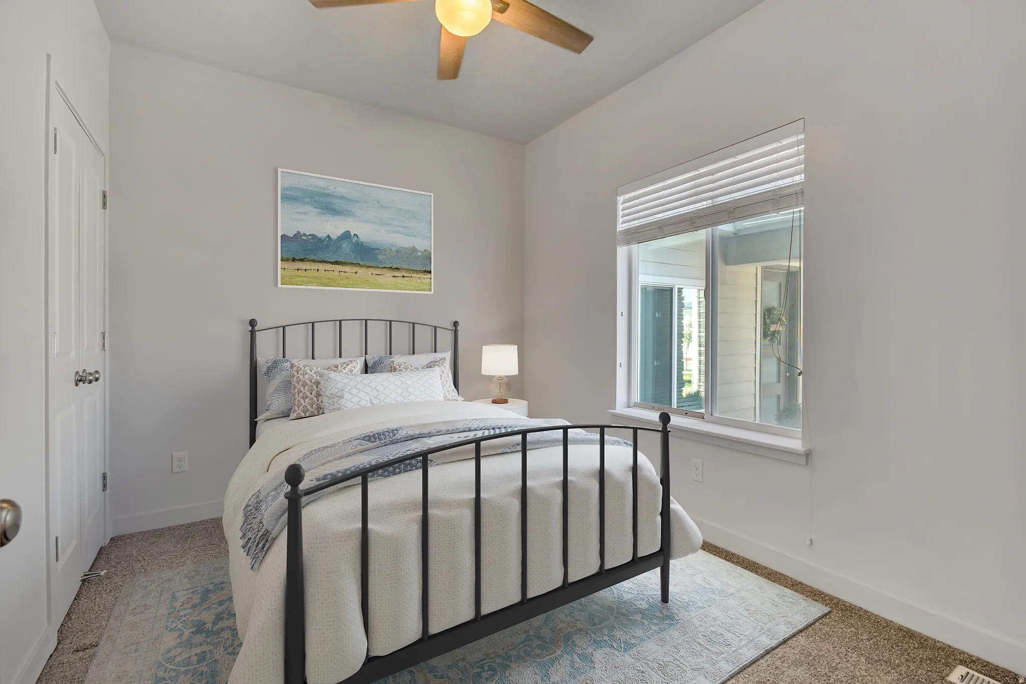 Carpeted room featuring a ceiling fan, a window with blinds, and white interior doors