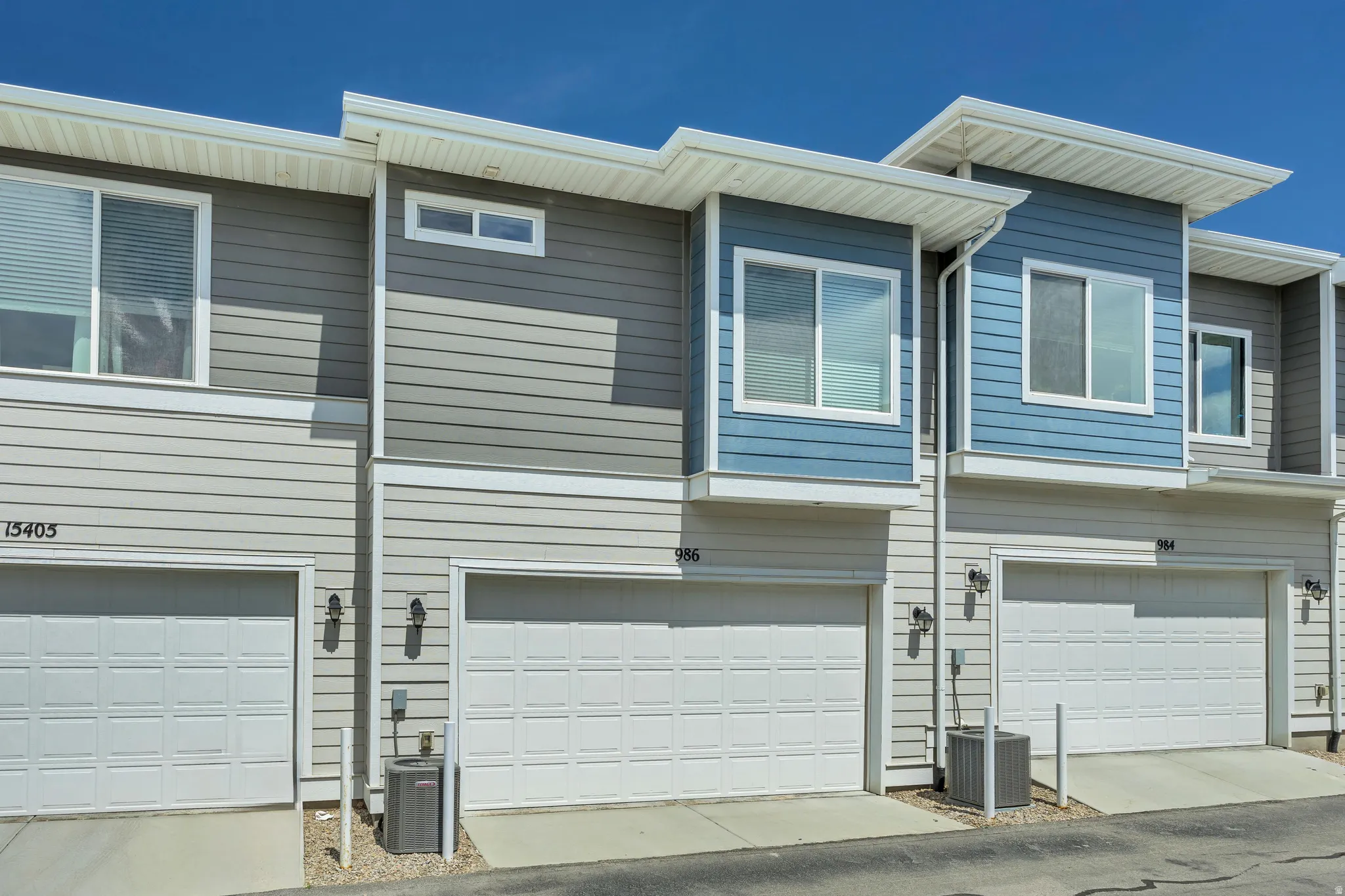 Townhome exterior featuring horizontal siding in light gray and blue tones
