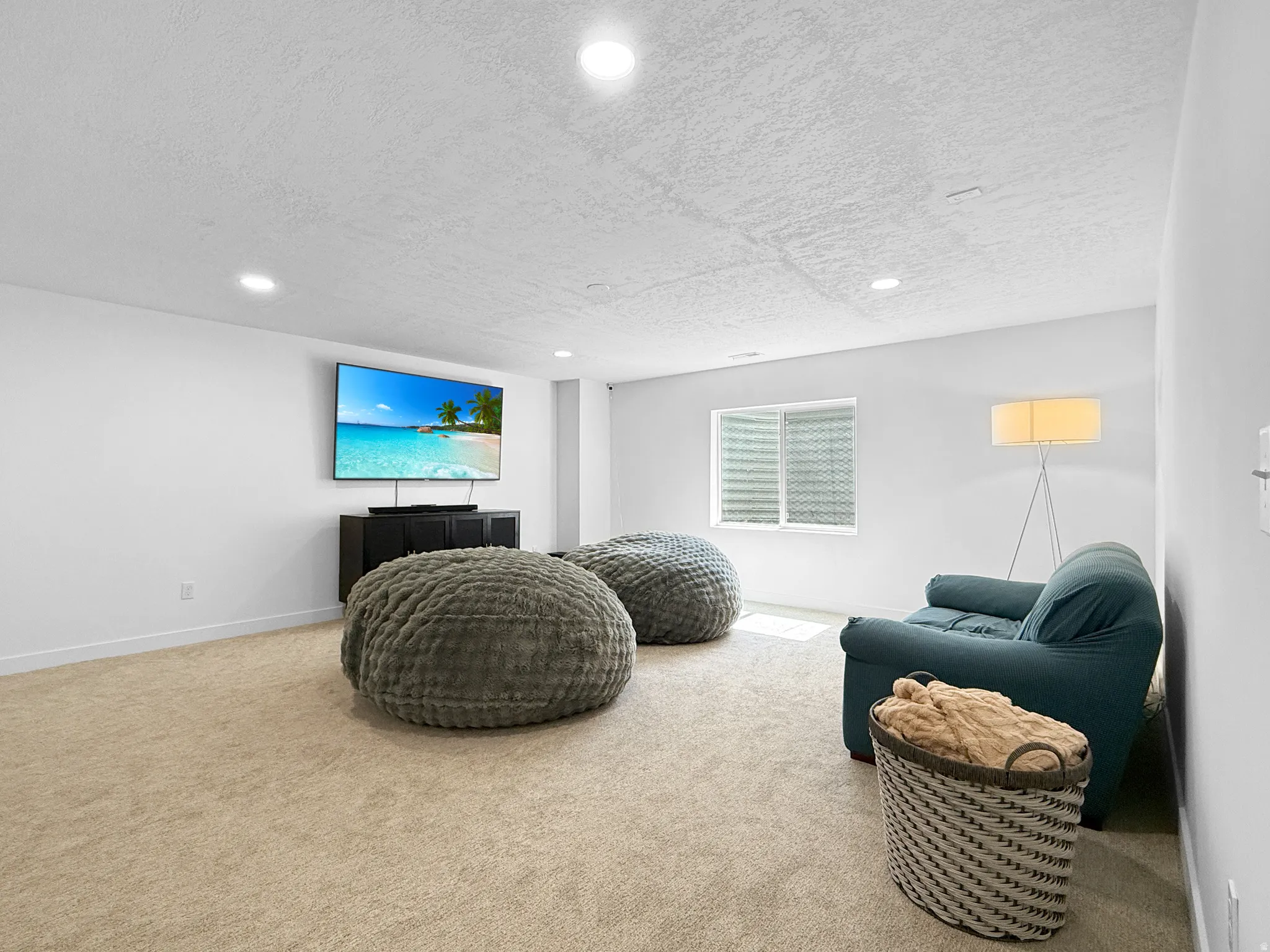 Spacious room with plush carpeting and light-toned walls