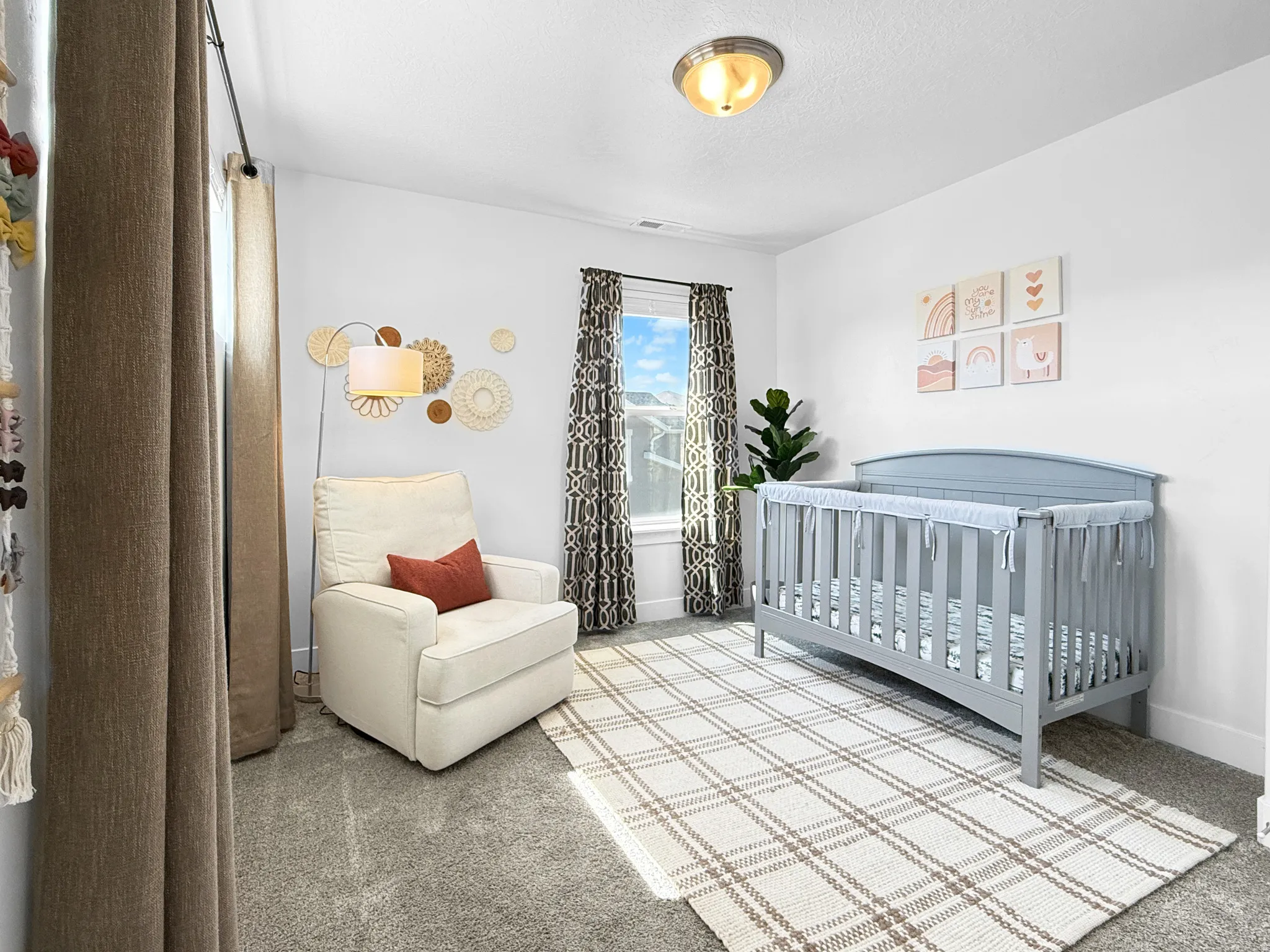 Bright room featuring white walls and a window with patterned curtains