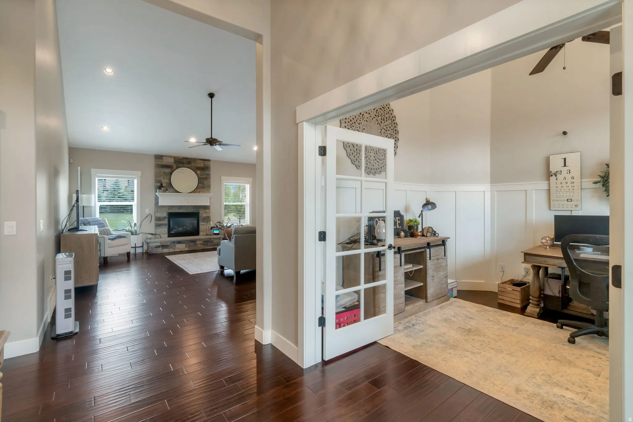 Office space with French doors, wainscoting, and wood-finish flooring