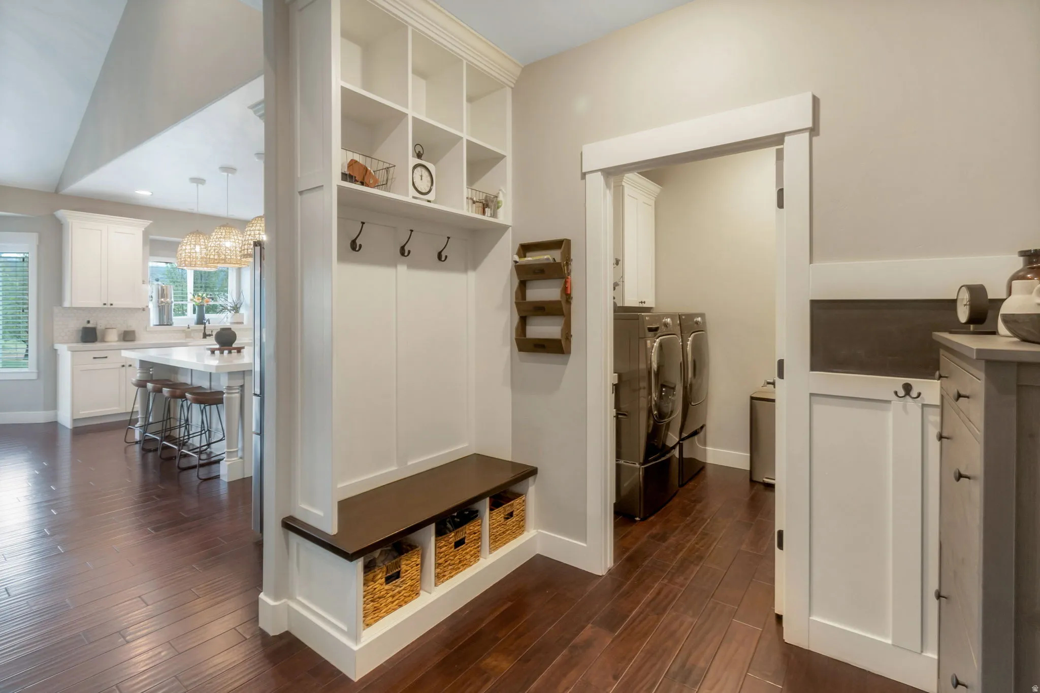 Built-in mudroom bench with cubbies, upper shelving, and coat hooks