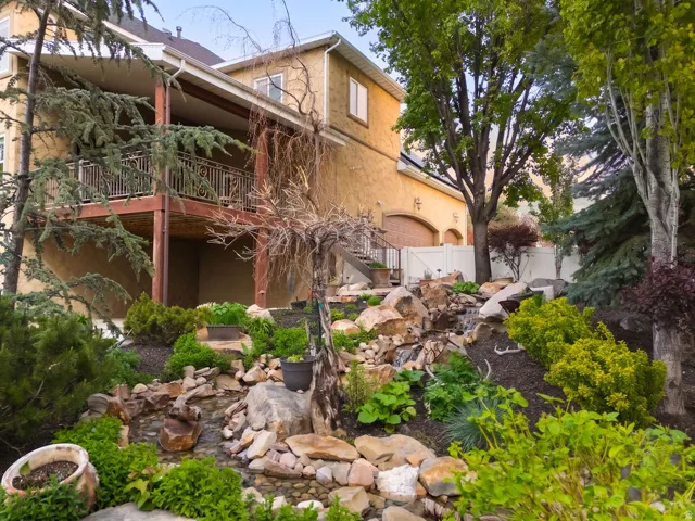 Multi-level terraced landscaping featuring a rock-lined stream and diverse plantings