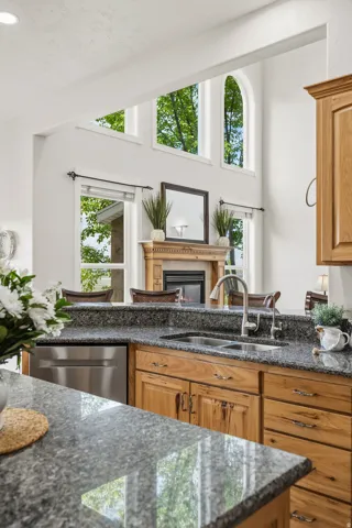 Kitchen featuring granite countertops, wood cabinetry, and stainless steel appliances