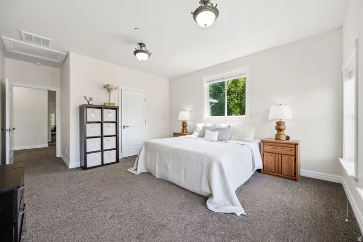 Bright interior space featuring neutral wall tones and plush carpet flooring