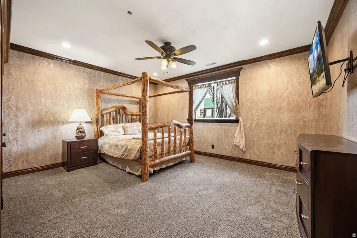 Spacious room featuring textured walls, dark wood trim, and recessed lighting
