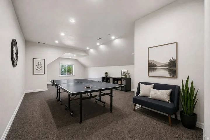 Carpeted bonus room with recessed lighting, sloped ceilings, and a window providing natural light