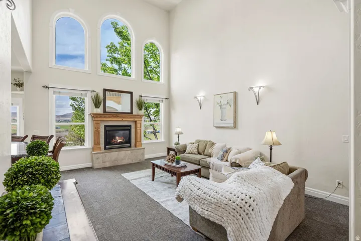 Living area with soaring ceilings and abundant natural light from multiple arched windows