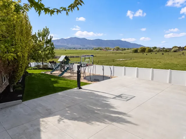 Expansive concrete patio area extending to a green lawn