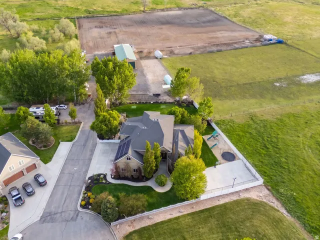 Aerial perspective showcasing a spacious property with a large residence, detached garage, and expansive grounds