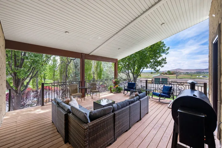 Covered outdoor deck with wood-finish flooring
