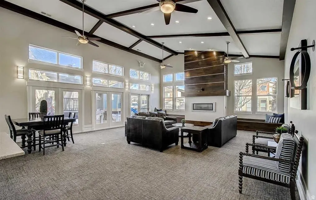 Vaulted ceiling with exposed beams and ceiling fans