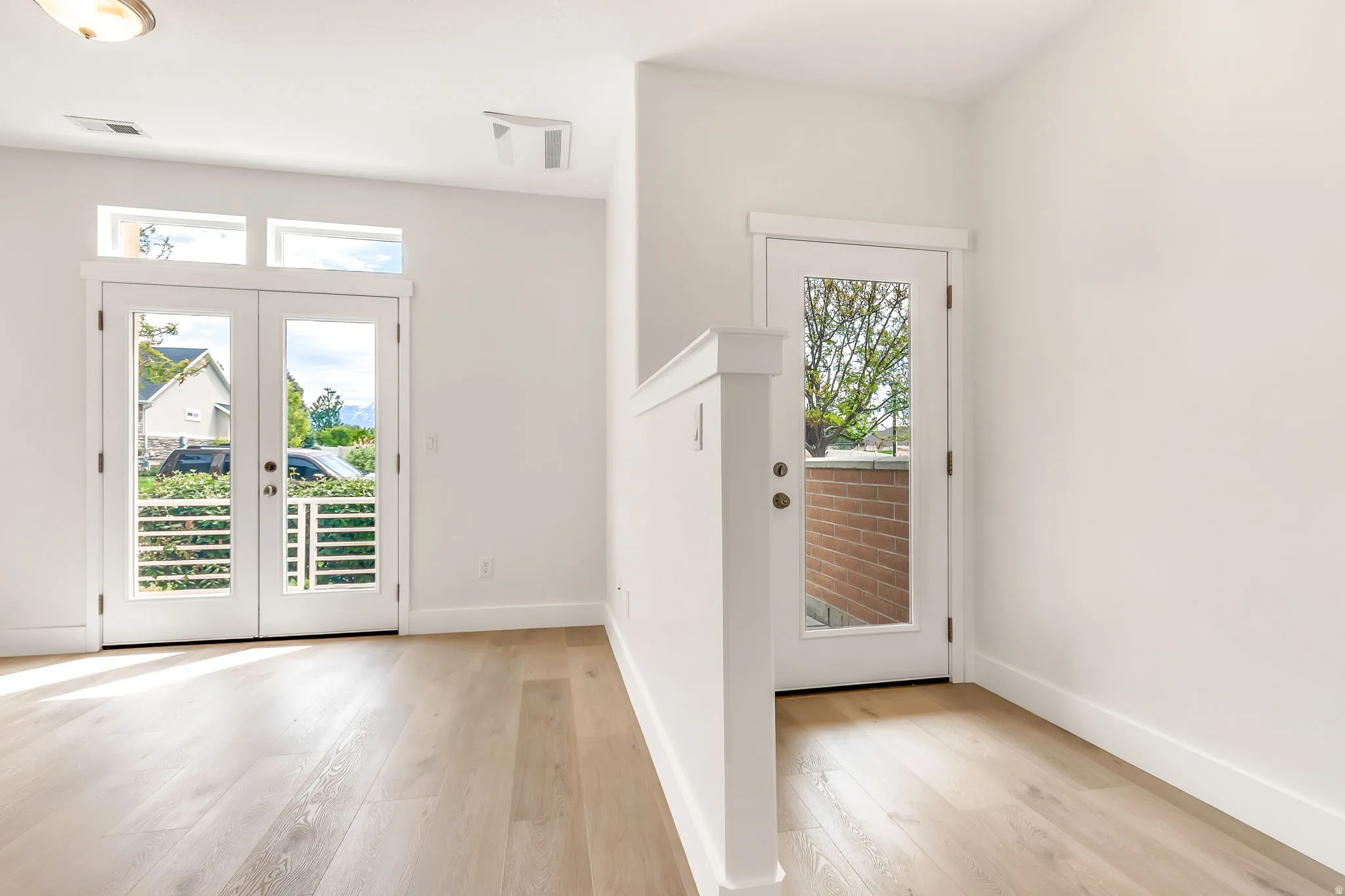 Hardwood-finish flooring throughout, complemented by crisp white walls and trim