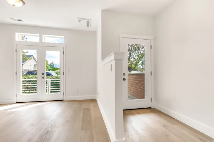 Hardwood-finish flooring throughout, complemented by crisp white walls and trim