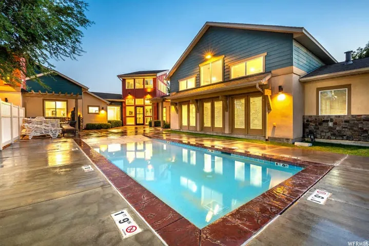 Outdoor swimming pool with stamped concrete surround and a decorative border