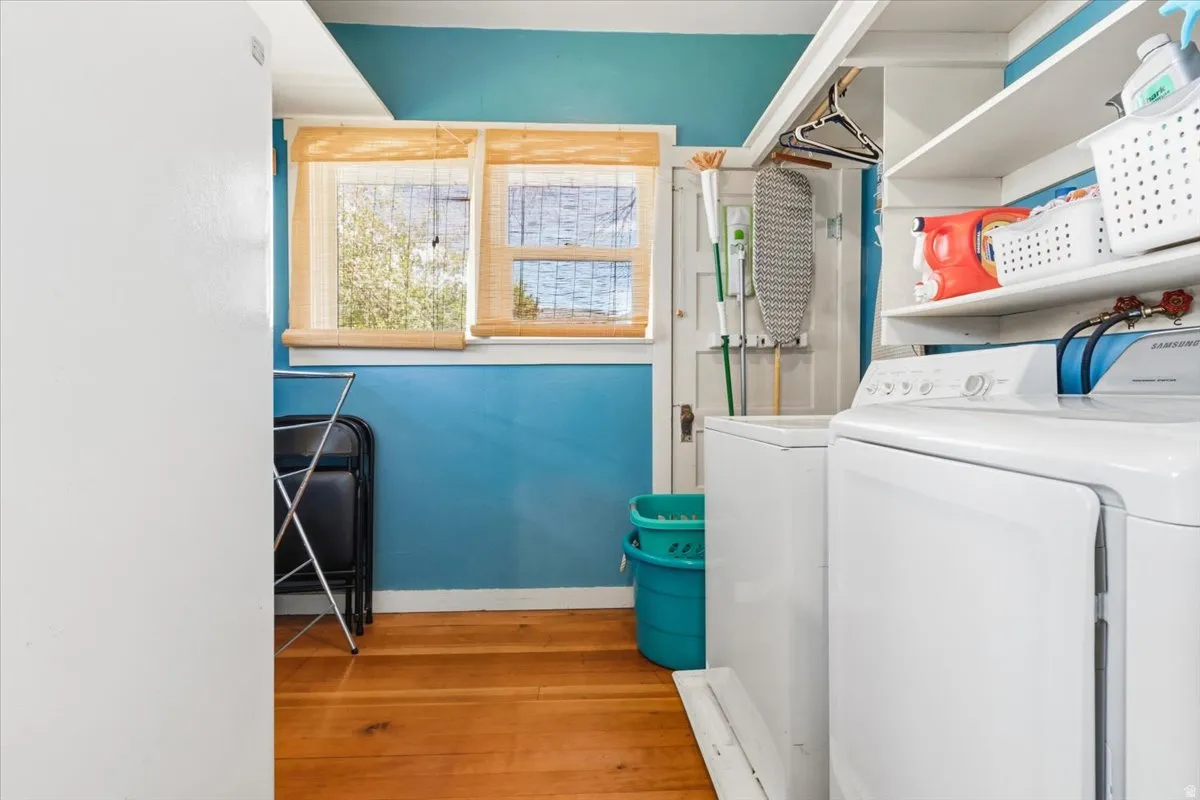 Dedicated laundry space with built-in shelving, and a hanging rod.