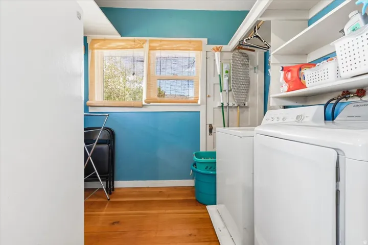 Dedicated laundry space with built-in shelving, and a hanging rod.