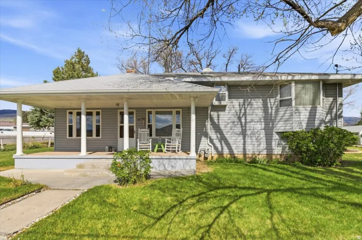 Light gray siding exterior with a covered front porch featuring white support columns