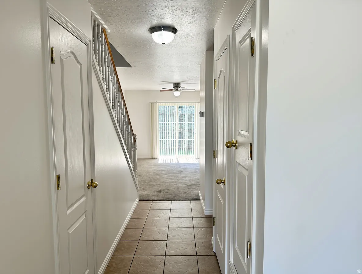 Tiled entryway flooring extending to a carpeted living area