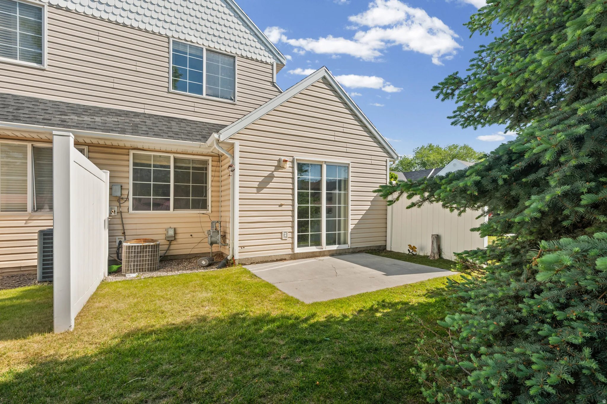 Private outdoor patio with sliding glass door access to the interior