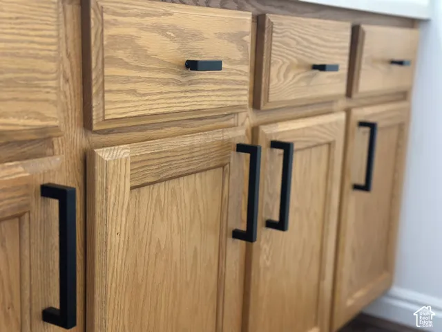 Wood-finish cabinetry with contemporary matte black hardware