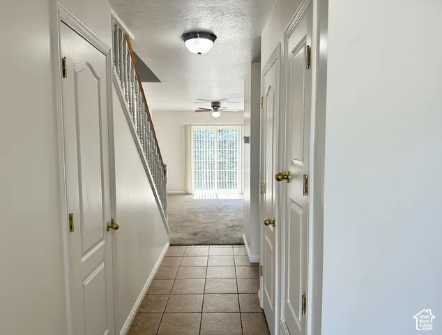 Tiled entryway flooring extending to a carpeted living area