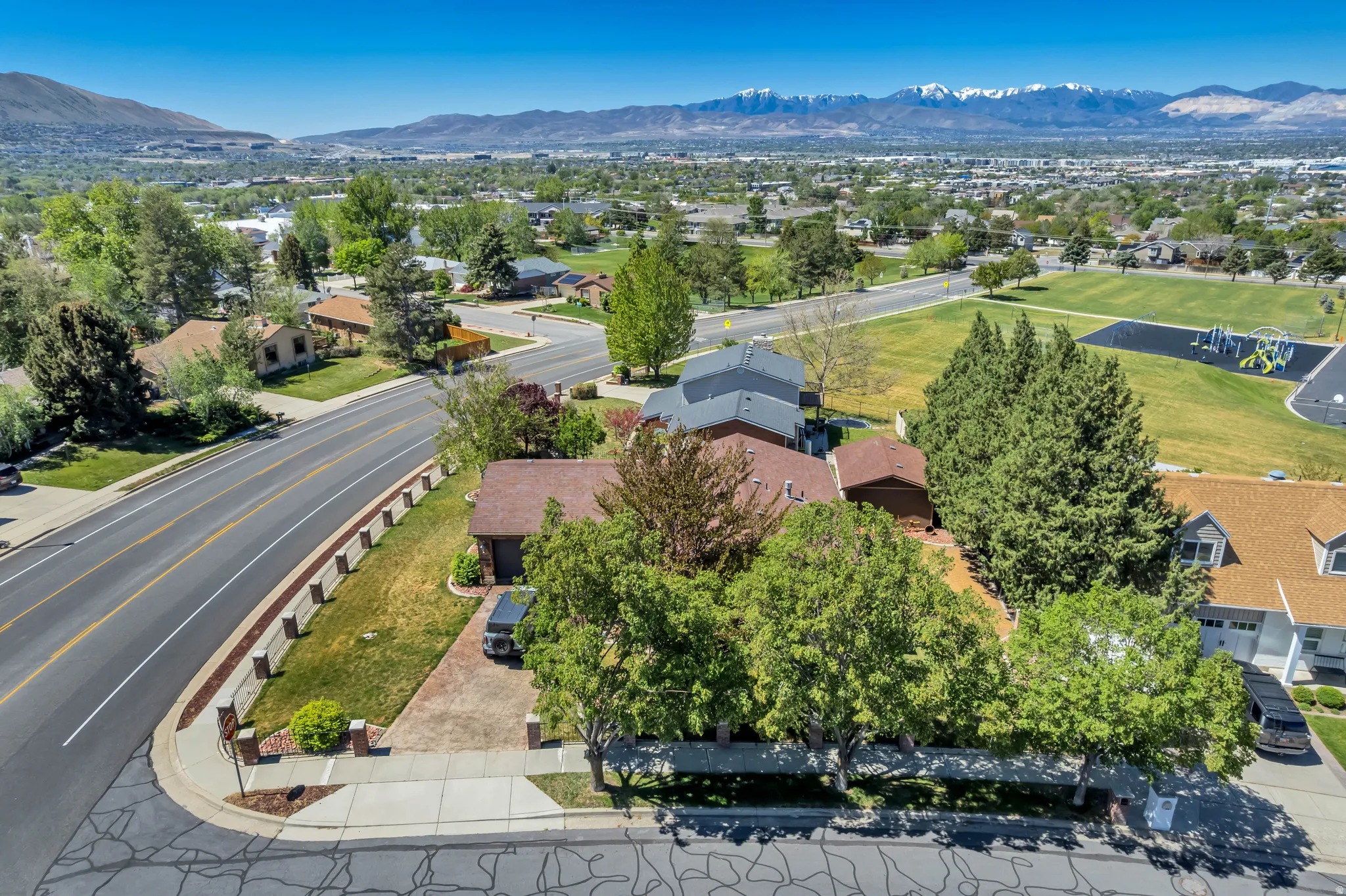 Aerial perspective showcasing a residential area with a paved street