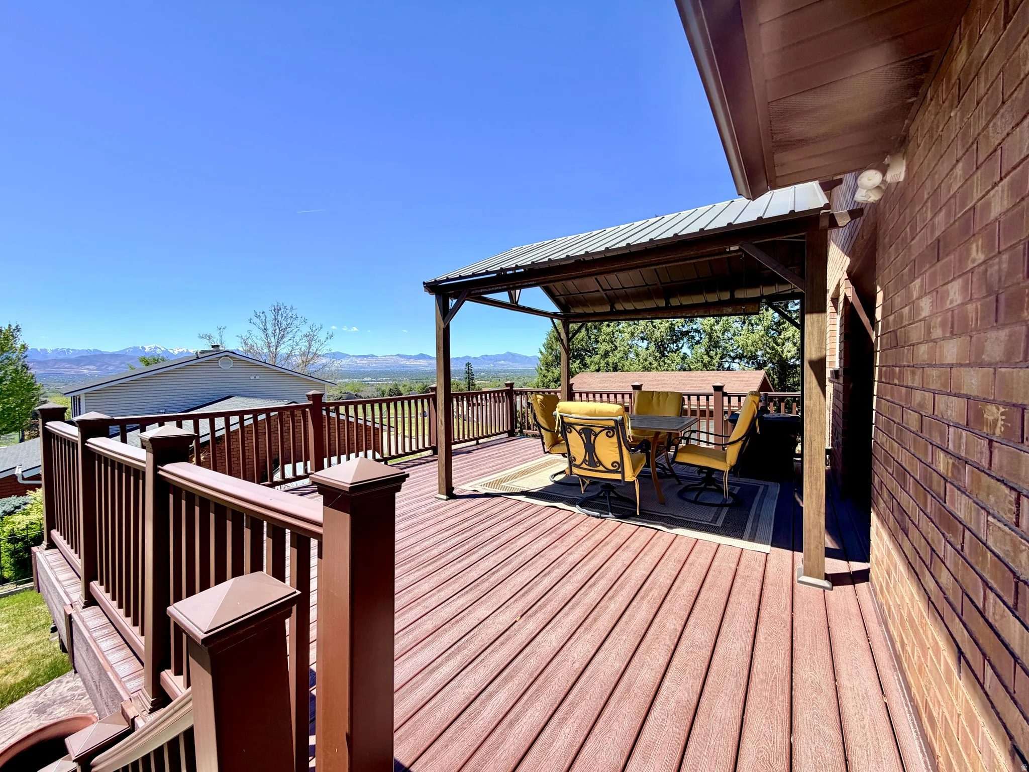 Expansive outdoor deck featuring composite decking and a covered gazebo