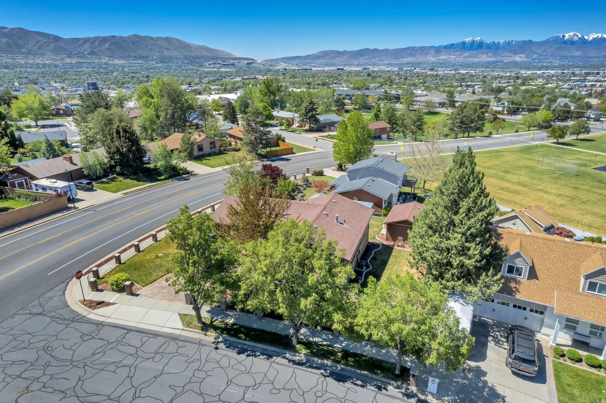 Expansive corner property with mature landscaping and mountain backdrop