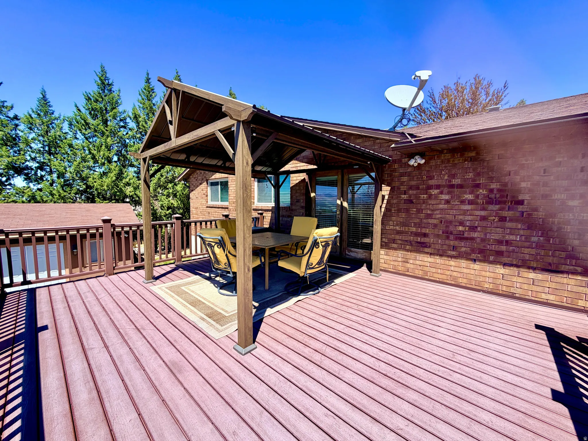 Expansive outdoor deck featuring wood-finish decking and a coordinating railing