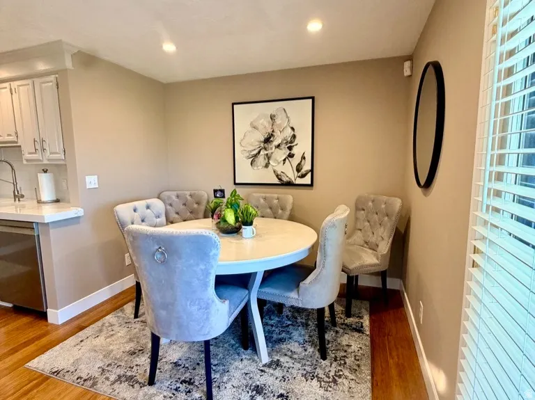 Dining area featuring warm wood-finish flooring, recessed lighting, and a neutral wall color