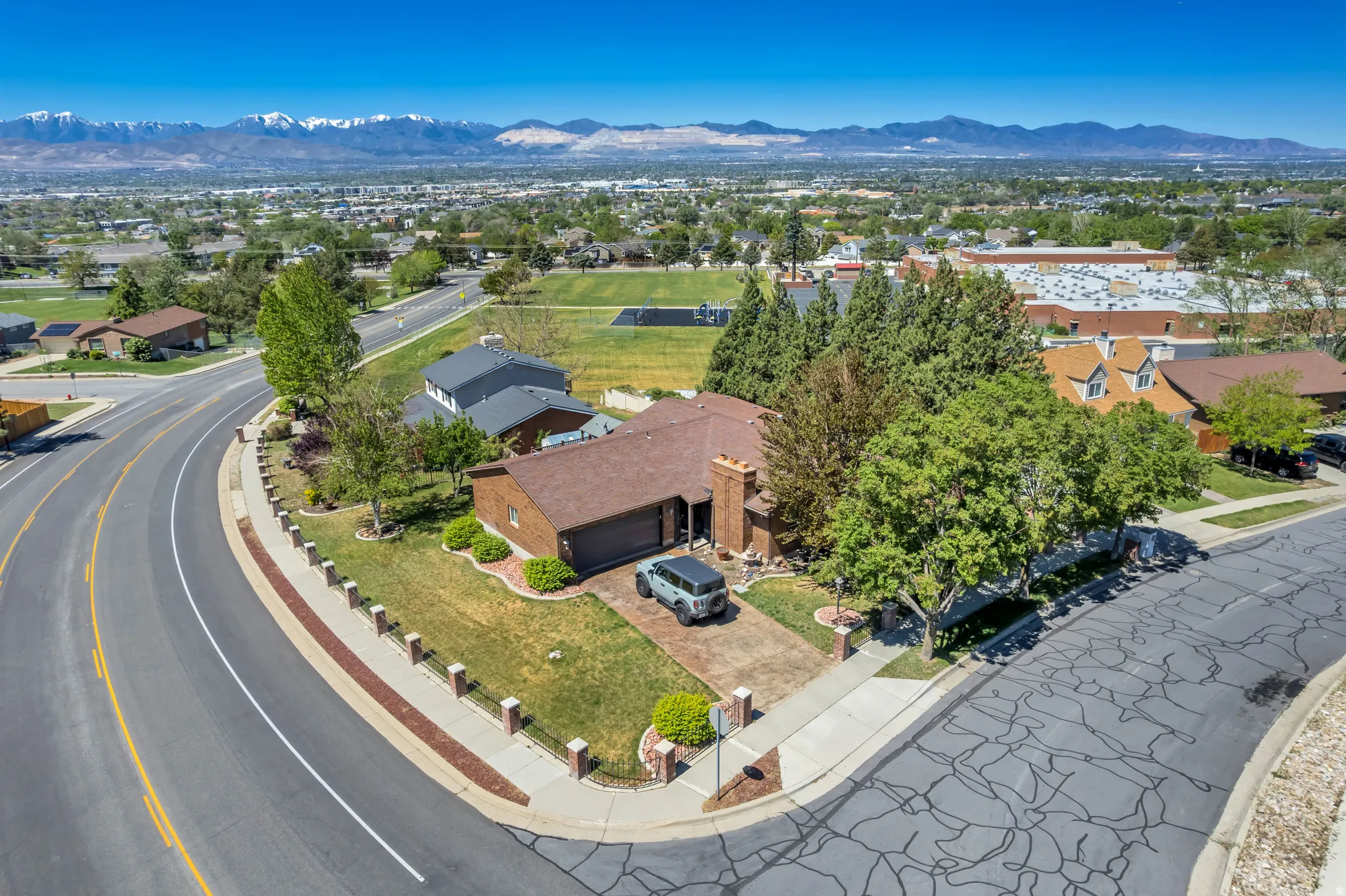 Single-story brick exterior home with an attached garage, situated on a corner lot