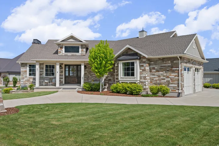 Stone and siding exterior with a prominent gabled dormer