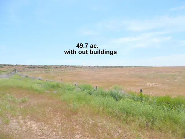 Expansive undeveloped parcel of land featuring natural vegetation and a clear horizon