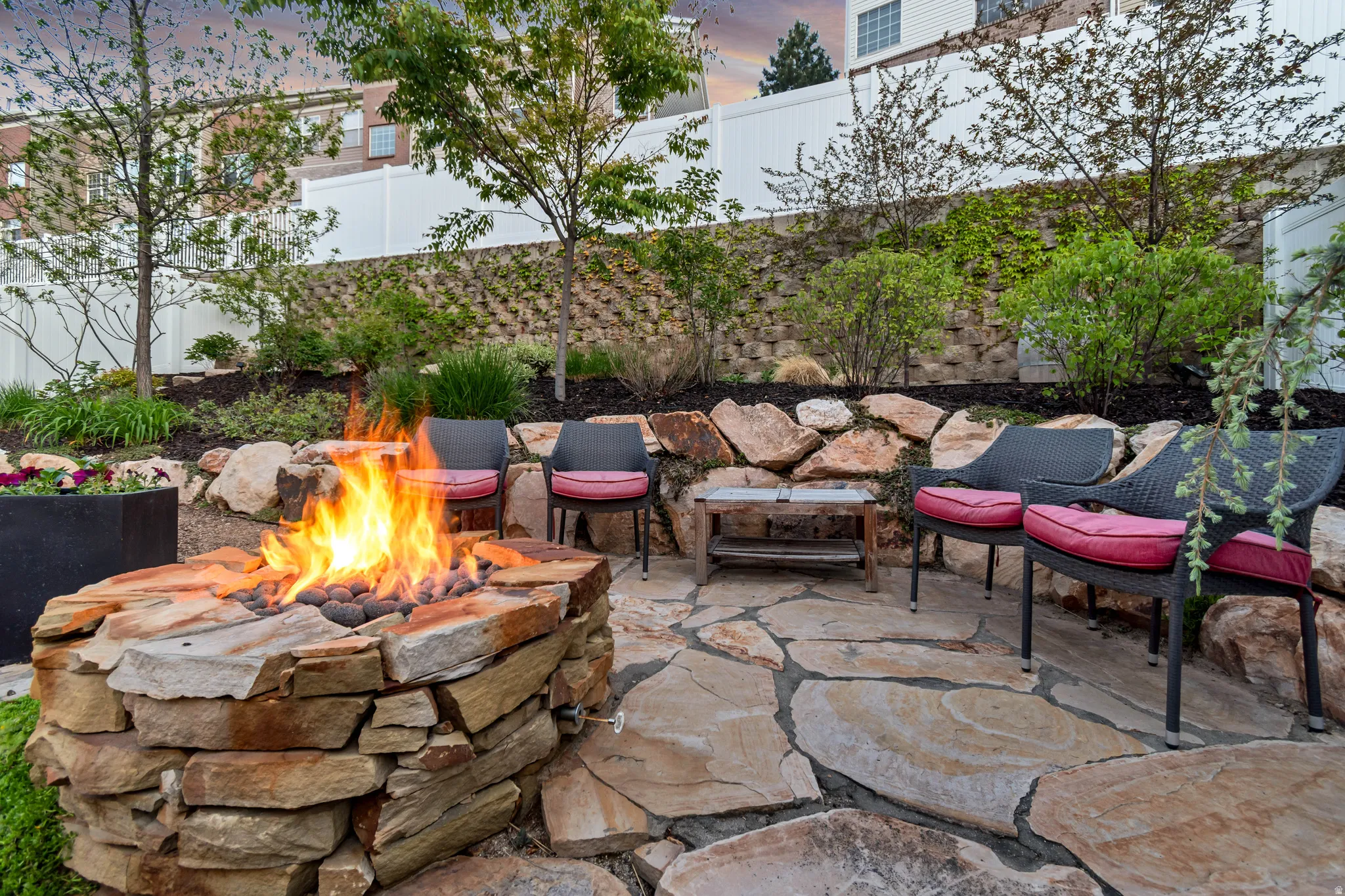 Stone fire pit with gas logs and flagstone patio
