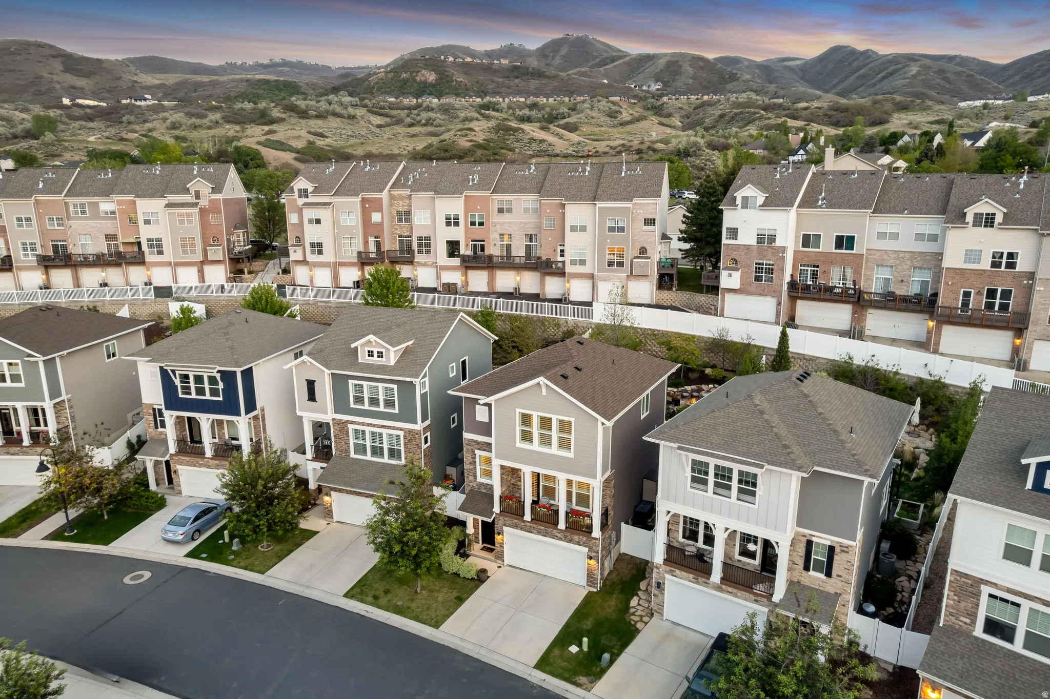 Residential neighborhood featuring a variety of architectural styles, paved roadways, and integrated garages
