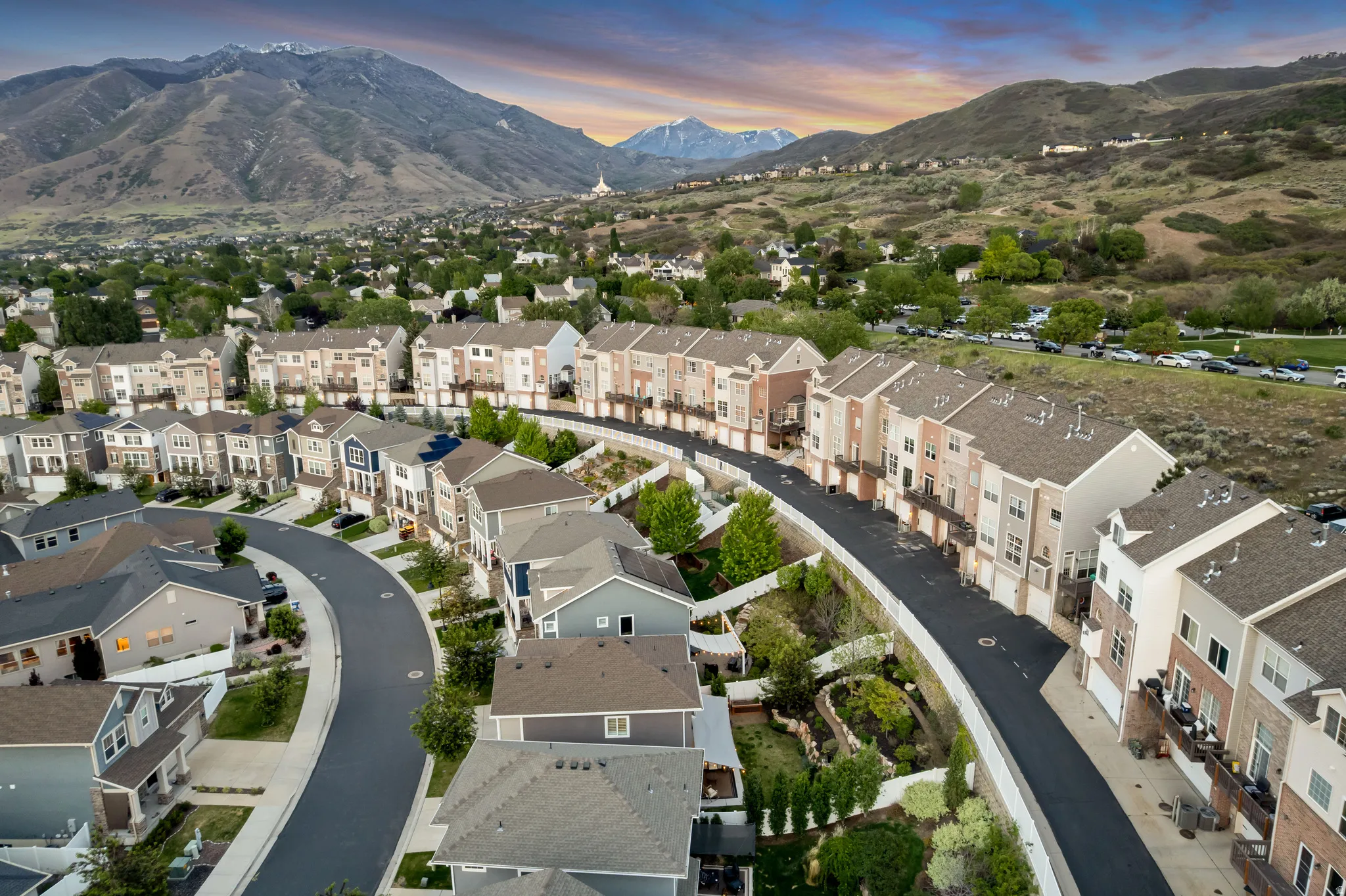 Aerial perspective of a developed residential area featuring a curvilinear street layout and a variety of architectural styles