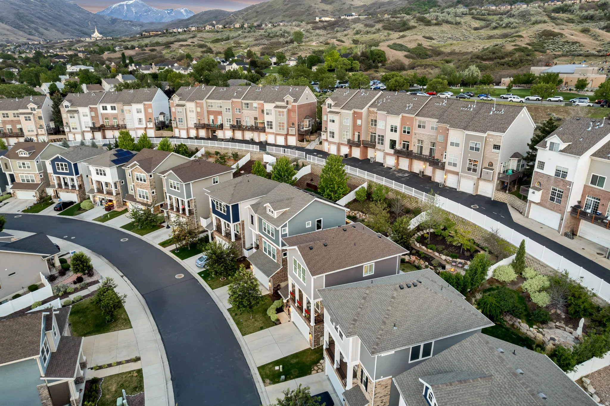 Modern residential development featuring multi-story townhomes and single-family residences