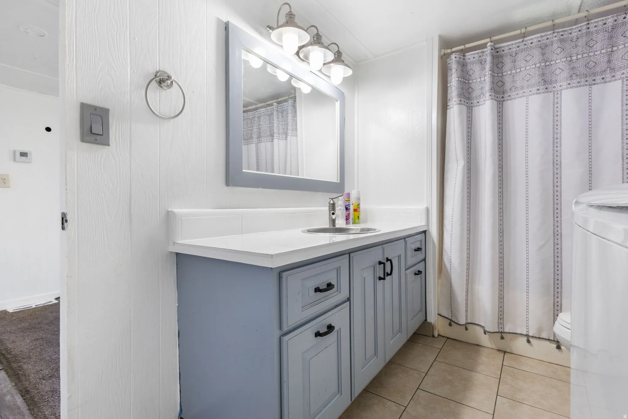 Bathroom vanity featuring a light blue base, a white countertop, and a rectangular sink