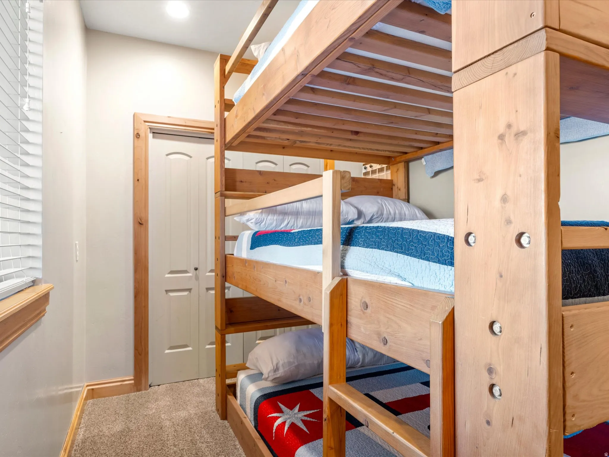 Custom-built wood bunk beds with integrated ladder
