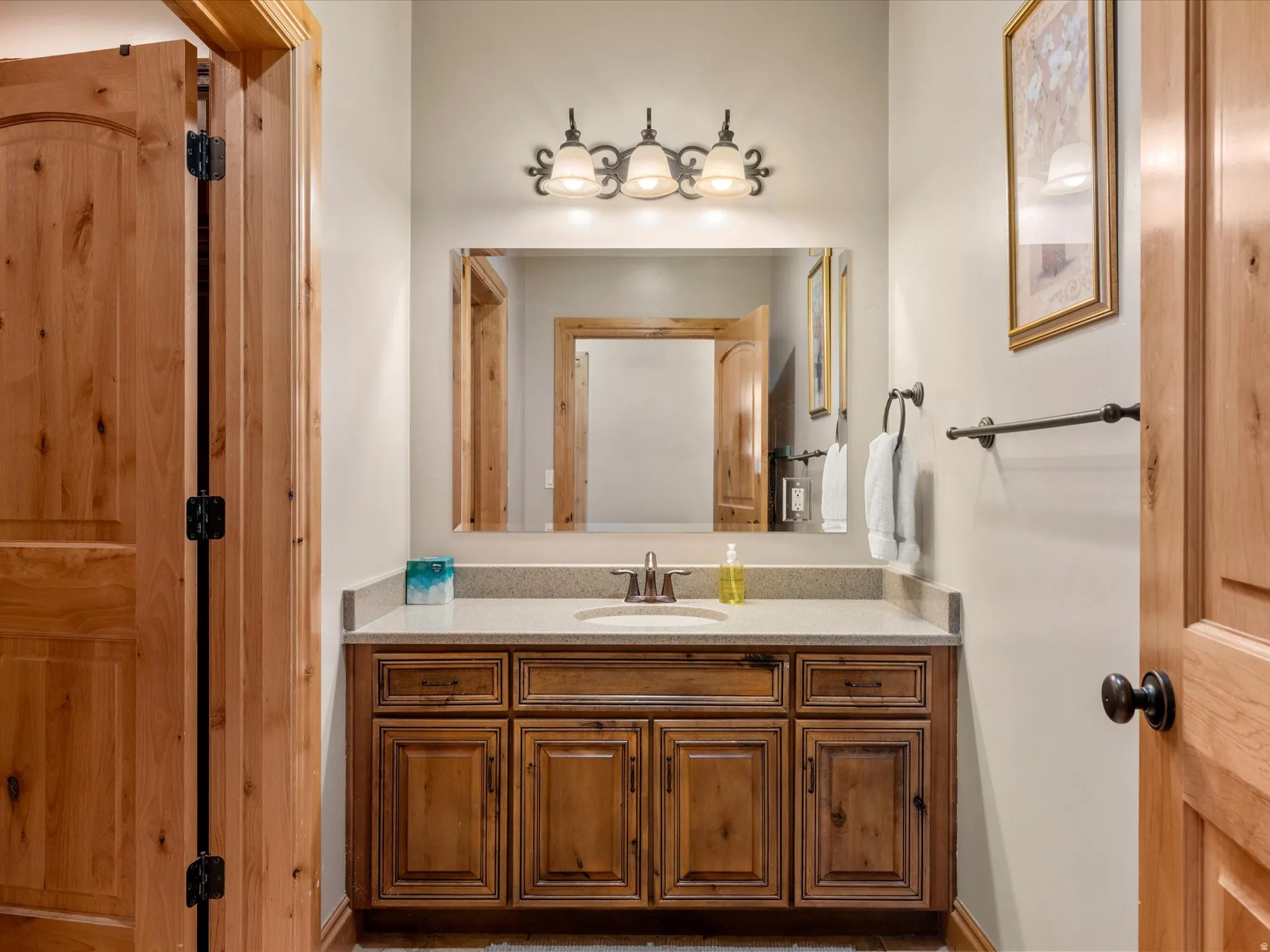 Warm wood-finish cabinetry with an integrated sink and light-toned countertop