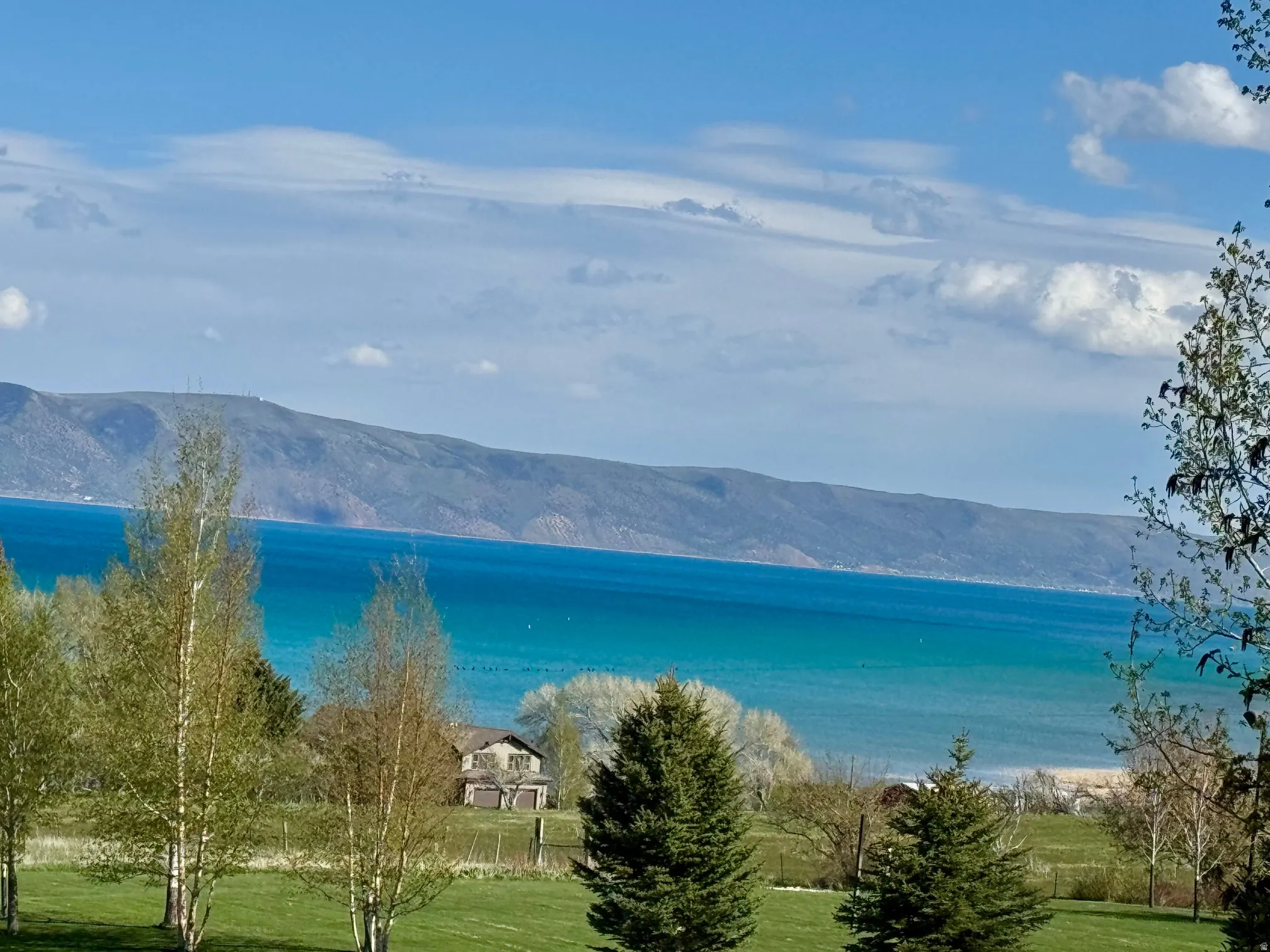 Expansive water body with surrounding mountains