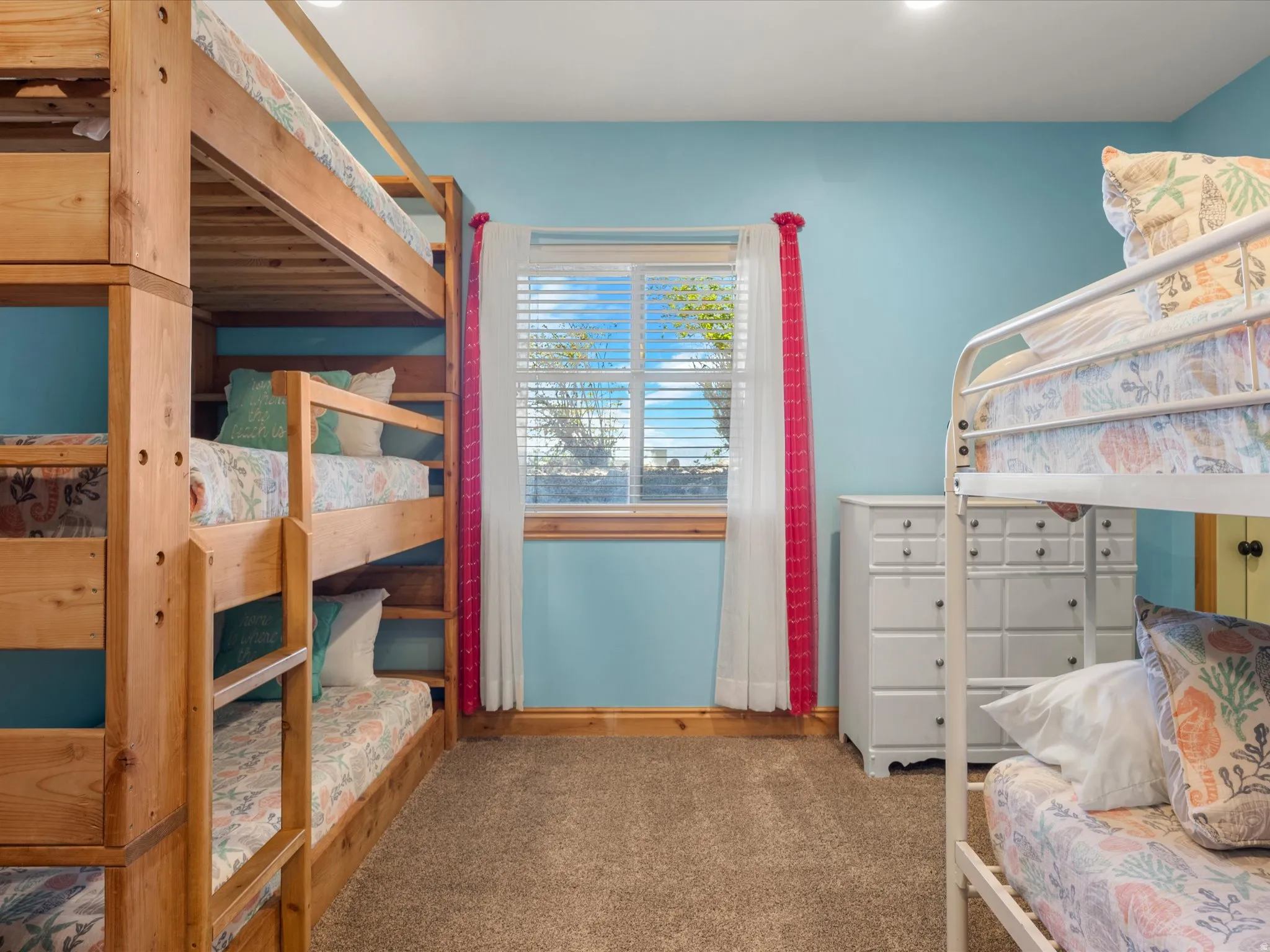 Bedroom with light blue walls and brown carpet flooring